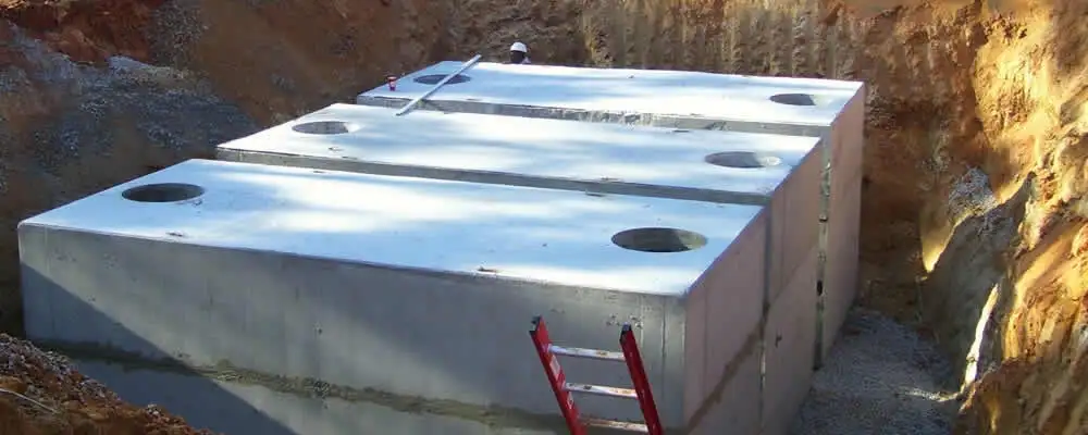 Septic tank installation site with a newly placed concrete tank in Bakersfield, CA